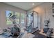 Home gym with elliptical, weight rack, and natural light at 6218 E Forest Pleasant Pl, Cave Creek, AZ 85331