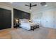 Main bedroom with king-size bed, dark accent wall, and ceiling fan at 6218 E Forest Pleasant Pl, Cave Creek, AZ 85331