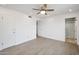 Bedroom with wood-look floors, ceiling fan and access to bathroom at 6249 S Parkside Dr, Tempe, AZ 85283