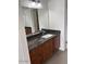 Bathroom vanity with granite countertop and dark wood cabinetry at 7800 E Lincoln Dr # 2047, Scottsdale, AZ 85250