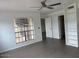 A bedroom with a ceiling fan, tiled floor, and built-in shelving at 7800 E Lincoln Dr # 2047, Scottsdale, AZ 85250