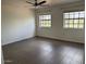 Bright bedroom with tile flooring, ceiling fan, and two windows with a view at 7800 E Lincoln Dr # 2047, Scottsdale, AZ 85250