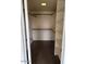 A large walk-in closet with rods, shelving, and tiled floors at 7800 E Lincoln Dr # 2047, Scottsdale, AZ 85250