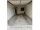 A spacious, empty garage with a concrete floor offers ample parking and storage solutions at 7800 E Lincoln Dr # 2047, Scottsdale, AZ 85250