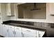 Kitchen features granite countertops, white cabinets, and an open view of the living space at 7800 E Lincoln Dr # 2047, Scottsdale, AZ 85250