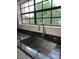 Close-up of kitchen sink and granite countertop with a view of the yard through a window at 7800 E Lincoln Dr # 2047, Scottsdale, AZ 85250