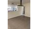 Inviting living area with tiled floors, modern light fixture, and bright kitchen view at 7800 E Lincoln Dr # 2047, Scottsdale, AZ 85250