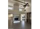 Spacious living room boasting a fireplace, tile flooring, and a ceiling fan at 7800 E Lincoln Dr # 2047, Scottsdale, AZ 85250