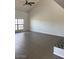 Open living room with tiled floor, large window, and vaulted ceiling at 7800 E Lincoln Dr # 2047, Scottsdale, AZ 85250
