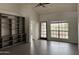 Bright living room featuring built-in shelving, tile flooring, and natural light from large windows at 7800 E Lincoln Dr # 2047, Scottsdale, AZ 85250