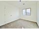 Well-lit bedroom with neutral carpeting and a window at 10073 W Mission Dr, Arizona City, AZ 85123