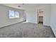 Spacious bedroom with gray carpeting and walk-in closet at 10073 W Mission Dr, Arizona City, AZ 85123