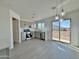 Modern kitchen features gray cabinets, stainless steel appliances, and sliding door to backyard at 10073 W Mission Dr, Arizona City, AZ 85123