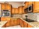 Kitchen with granite countertops and wood cabinets at 10283 E Fortuna Ave, Gold Canyon, AZ 85118