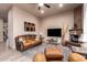 Living room with stone fireplace and TV at 10283 E Fortuna Ave, Gold Canyon, AZ 85118