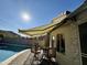 Relaxing patio with pool view, retractable awning, and seating area at 10283 E Fortuna Ave, Gold Canyon, AZ 85118