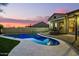 Relaxing kidney-shaped pool in the backyard, surrounded by a stone patio at 10283 E Fortuna Ave, Gold Canyon, AZ 85118