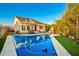 Large rectangular pool with a patio and lush green landscaping at 10283 E Fortuna Ave, Gold Canyon, AZ 85118