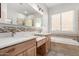 Bathroom with double sinks, bathtub and shower at 11065 E Mark Ln, Scottsdale, AZ 85262