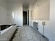 Bathroom with hexagonal tile floor, soaking tub, and vanity at 11446 E Utah Ave, Mesa, AZ 85212