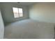 Spacious bedroom with large window and neutral wall color at 11446 E Utah Ave, Mesa, AZ 85212