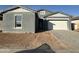 Gray house with white garage door and newly landscaped front yard at 11446 E Utah Ave, Mesa, AZ 85212