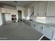 Modern kitchen with white cabinets, quartz countertops, and an island at 11446 E Utah Ave, Mesa, AZ 85212