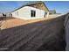 Unfinished home exterior with exposed framing and landscaping at 11457 E Utopia Ave, Mesa, AZ 85212