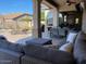 Relaxing covered patio with comfortable seating and dining area at 12803 W Campina Dr, Litchfield Park, AZ 85340