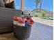 Poolside relaxation with towels ready by the wicker furniture at 12803 W Campina Dr, Litchfield Park, AZ 85340