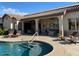 Inviting backyard oasis with a sparkling pool, spacious patio, and comfortable lounge area at 12803 W Campina Dr, Litchfield Park, AZ 85340