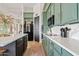 Modern kitchen with green cabinets and white countertops at 13231 N El Pueblo Blvd, Fountain Hills, AZ 85268