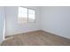 Simple bedroom with wood-look tile flooring and a window at 1357 E Cherrywood Pl, Chandler, AZ 85249