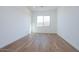 Simple bedroom with wood-look tile flooring and a window at 1357 E Cherrywood Pl, Chandler, AZ 85249