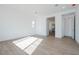 Sunlit bedroom with wood-look floors and en-suite bathroom at 1357 E Cherrywood Pl, Chandler, AZ 85249