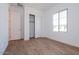 Spacious bedroom with wood-look tile flooring and sliding closet doors at 1357 E Cherrywood Pl, Chandler, AZ 85249