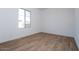 Bright bedroom with wood-look tile flooring and large window at 1357 E Cherrywood Pl, Chandler, AZ 85249