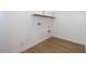 Bright laundry room with white cabinets and wood-look tile floor at 1357 E Cherrywood Pl, Chandler, AZ 85249