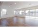 Bright and airy living room featuring wood-look tile flooring and sliding glass doors at 1357 E Cherrywood Pl, Chandler, AZ 85249