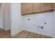 Laundry room with wood cabinets and tile floor at 1364 E Nolan Pl, Chandler, AZ 85249