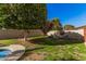 Landscaped backyard with fire pit and seating area at 14570 N 142Nd Ln, Surprise, AZ 85379