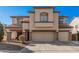 Two-story house with a large front yard and attached two-car garage at 14570 N 142Nd Ln, Surprise, AZ 85379