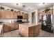 Large kitchen island with granite countertops and wood cabinets at 14570 N 142Nd Ln, Surprise, AZ 85379