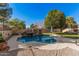 Inviting kidney-shaped pool with rock waterfall feature at 14570 N 142Nd Ln, Surprise, AZ 85379