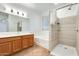 Modern bathroom featuring a soaking tub, shower, and double vanity at 14614 N 153Rd Ct, Surprise, AZ 85379