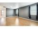 Well-lit bedroom, featuring wood floors and gray walls at 14614 N 153Rd Ct, Surprise, AZ 85379