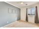 Spacious bedroom with gray accent wall and ceiling fan at 14614 N 153Rd Ct, Surprise, AZ 85379