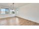 Bright dining room features wood-look floors and a modern light fixture at 14614 N 153Rd Ct, Surprise, AZ 85379