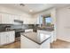 Spacious kitchen with an island, stainless steel appliances, and white cabinets at 14614 N 153Rd Ct, Surprise, AZ 85379