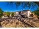 Large backyard with gravel and mature trees providing shade at 1502 E Angela Dr, Phoenix, AZ 85022